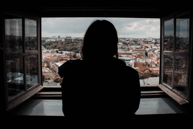 a woman looking out of a window