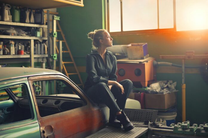 a woman sitting in a garage